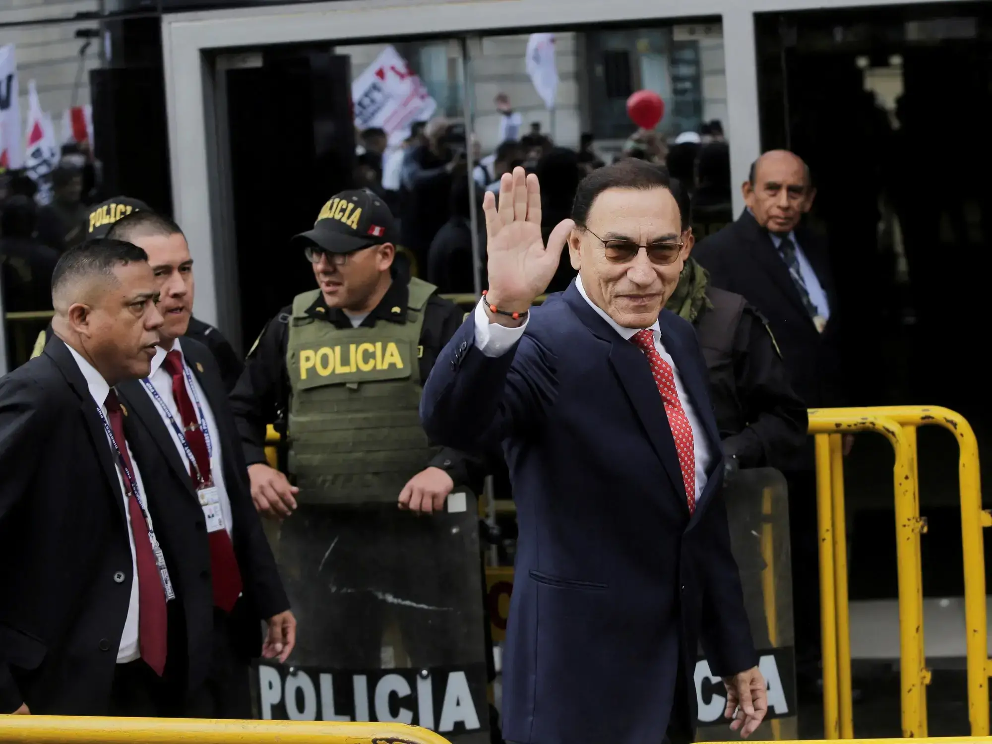 El expresidente peruano Martín Vizcarra saluda a su llegada al tribunal para escuchar la sentencia.