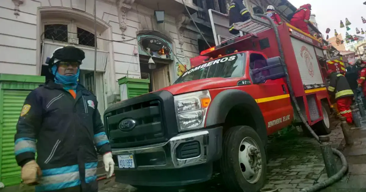 Bomberos trabajando en el enfriamiento del edificio colonial incendiado.