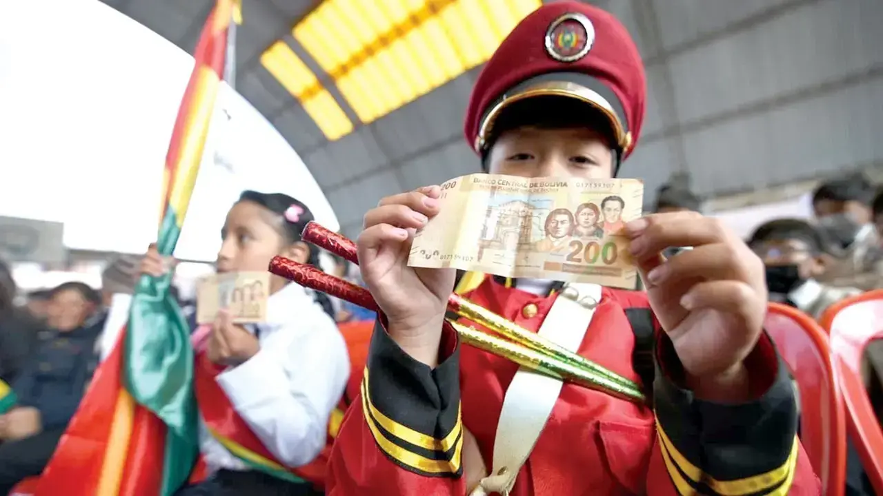 Estudiantes muestran su bono tras recibir este beneficio.