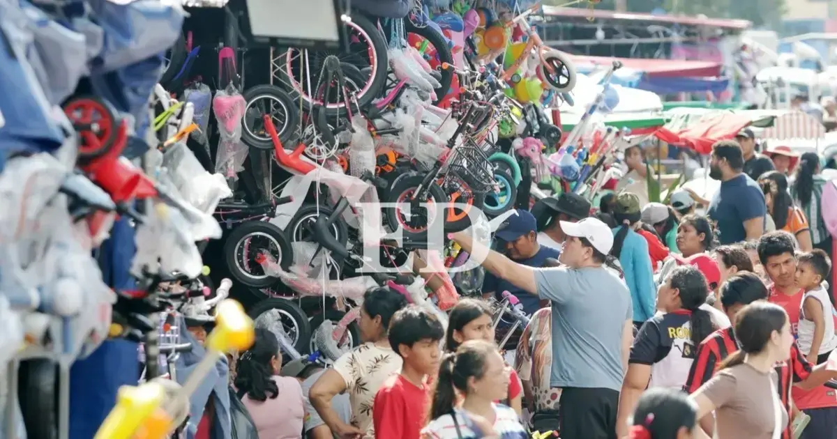 Personas realizando compras en un mercado navideno.