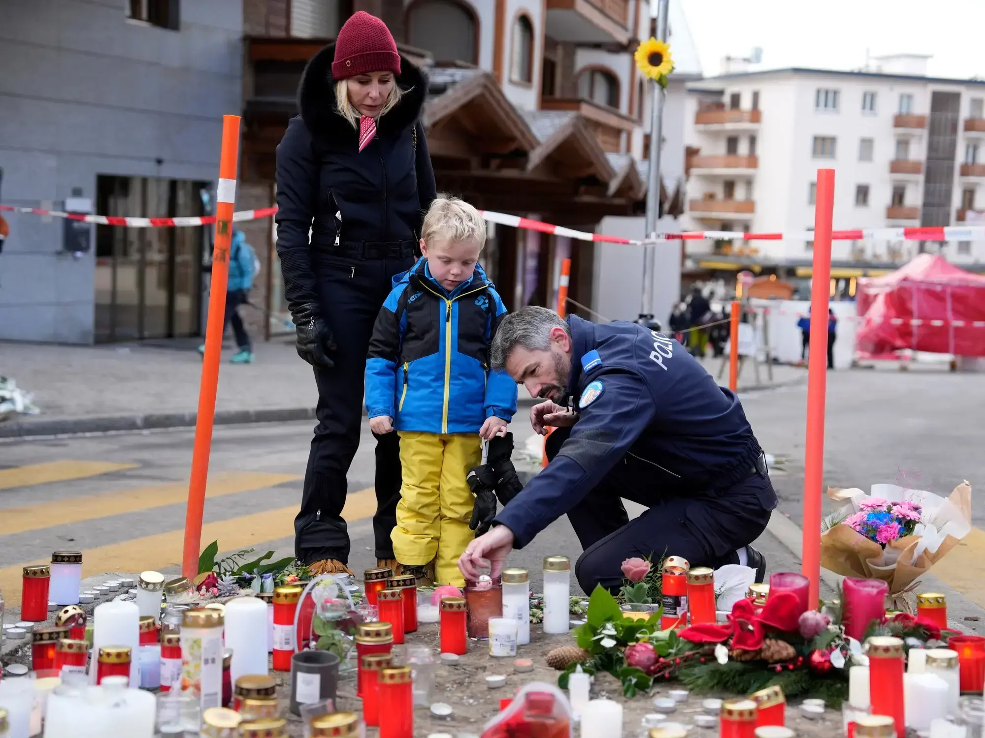 Personas dejan flores y velas cerca del bar Le Constellation en Crans-Montana.