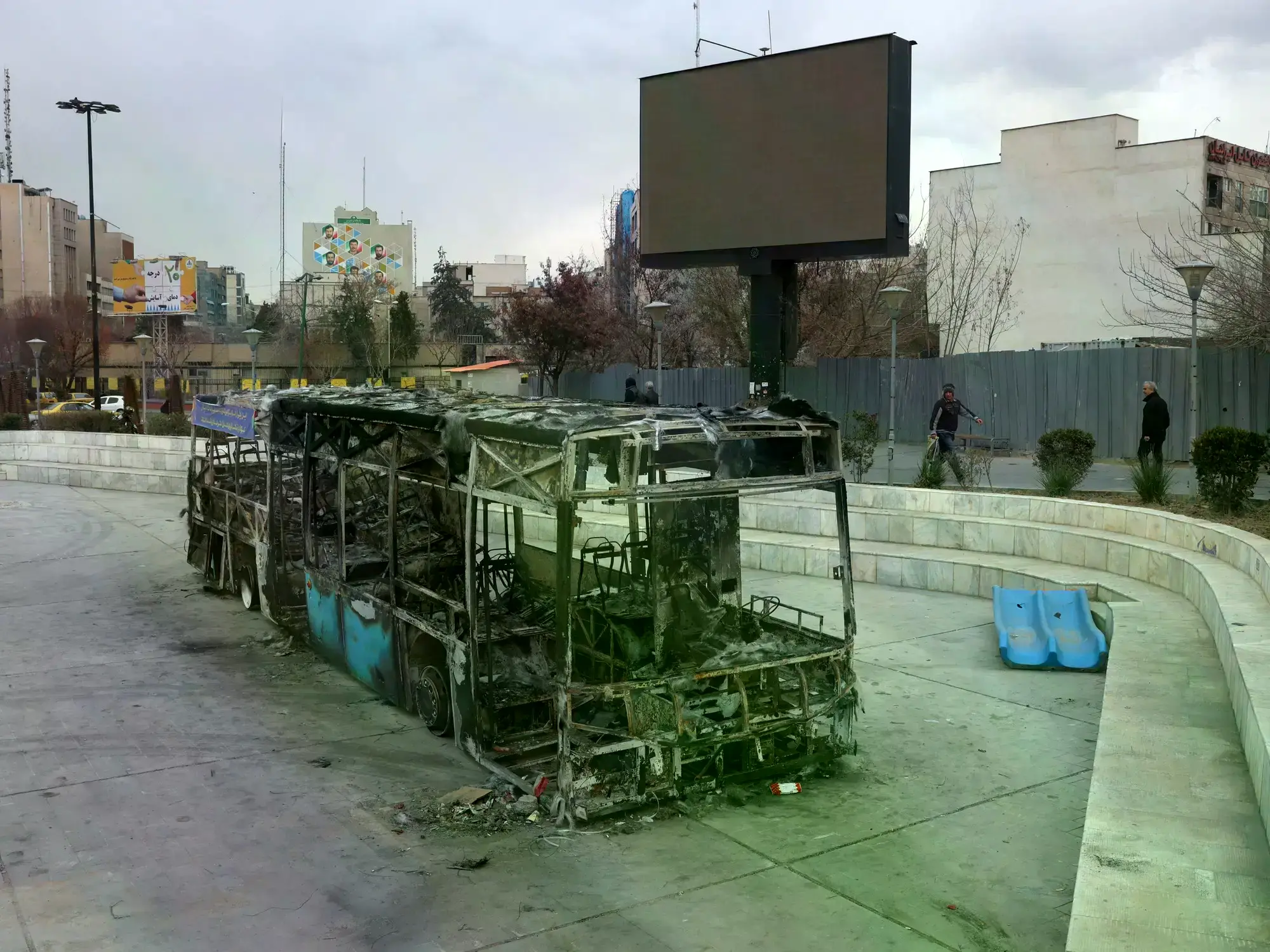 Un ómnibus incendiado durante las protestas en Teherán, Irán