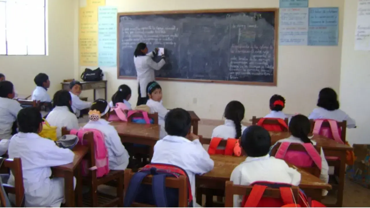 Maestros y escolares en un aula.