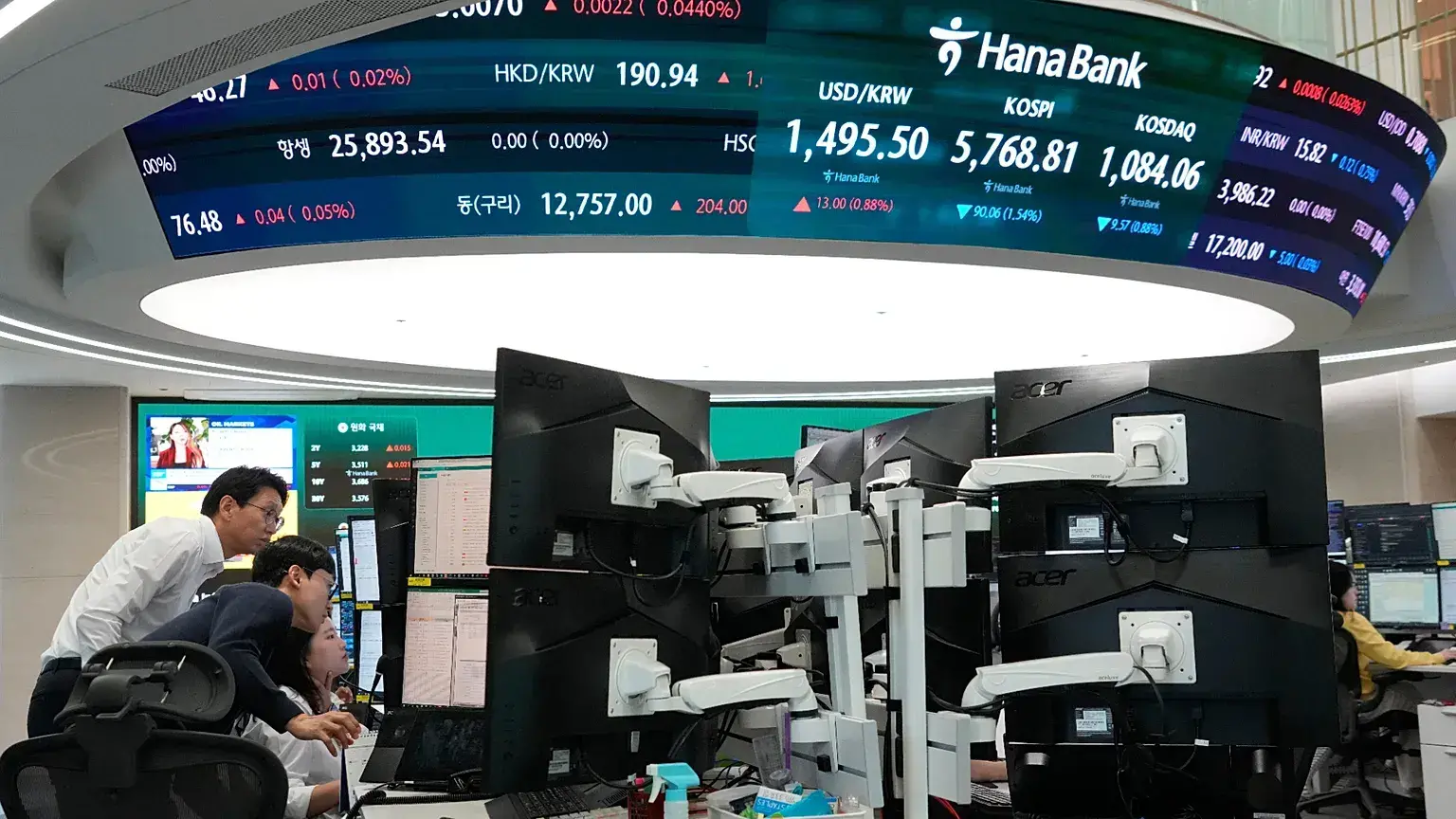 Operadores de divisas observan monitores en la sede de Hana Bank en Seúl