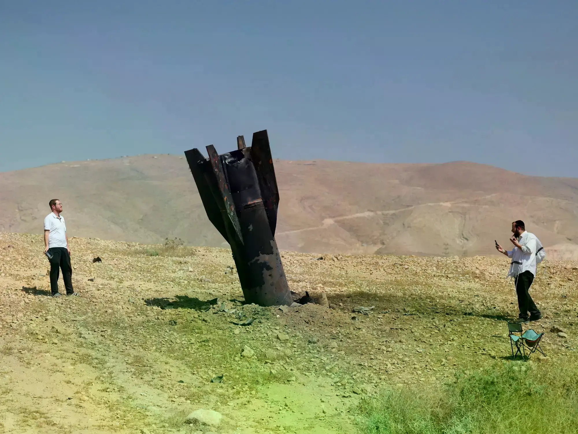 Judíos ultraortodoxos miran los restos de un misil balístico iraní en Cisjordania.