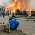 Un hombre observa casas afectadas por incendios forestales en Chile.